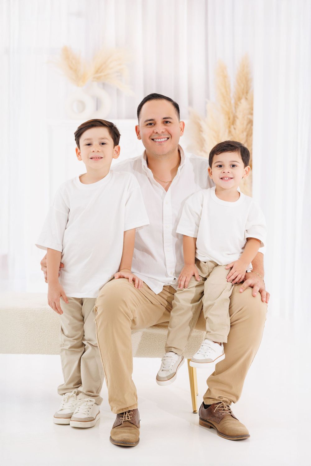 Close-up family portrait showing coordinated white shirts and khaki pants.