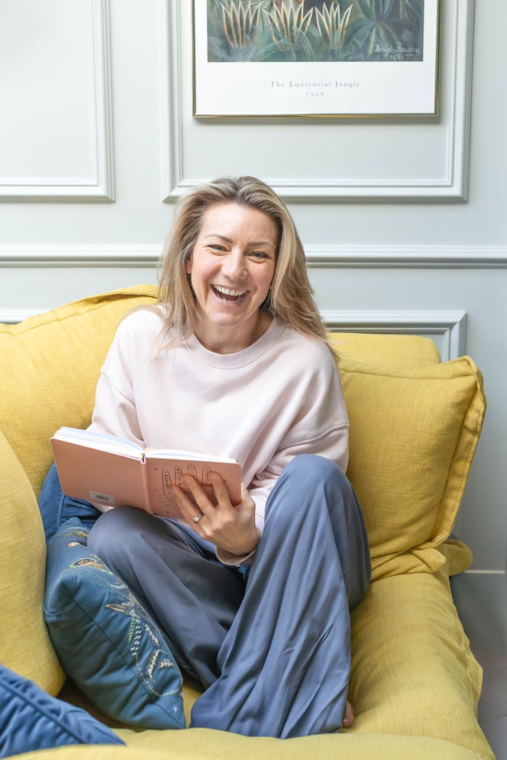 portrait of a therapist sat on a couch reading a book