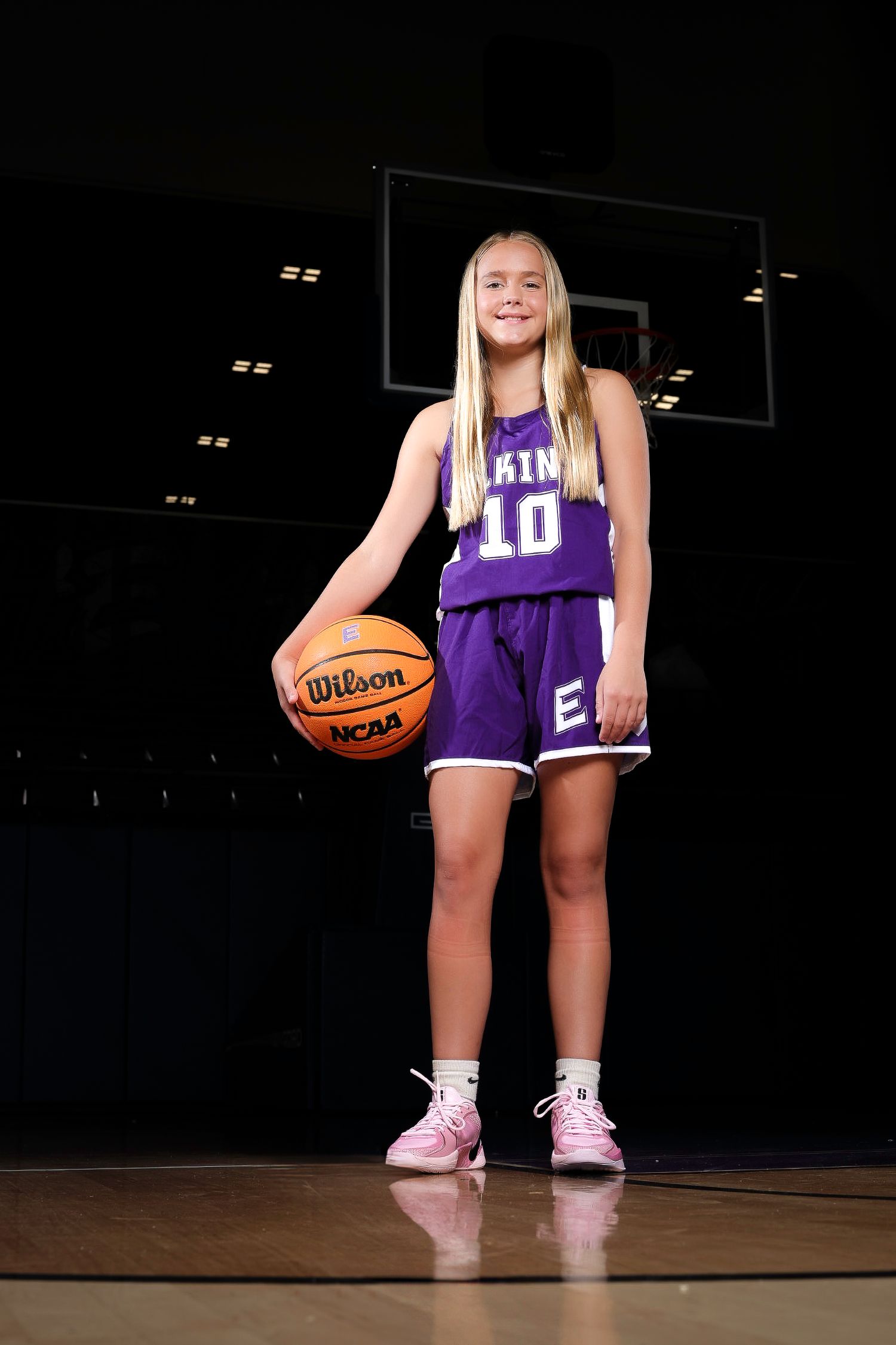 Elkins AR volleyball player posing with ball in gym – Elkins Elks sports portrait.