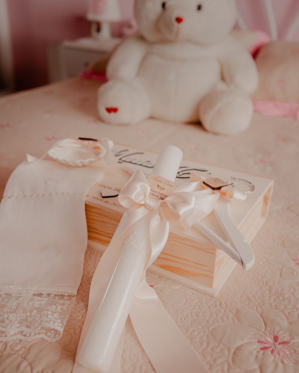 Delicate white lace decorations and stuffed animals arranged on a table setting.