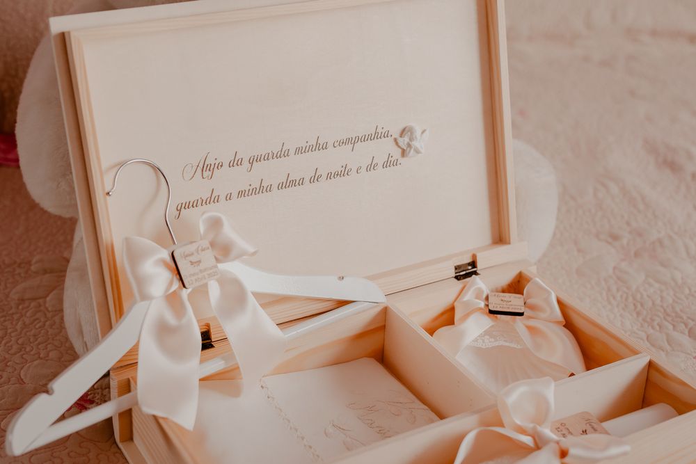 Close-up of ornate white baptism celebration stationery with elegant typography.