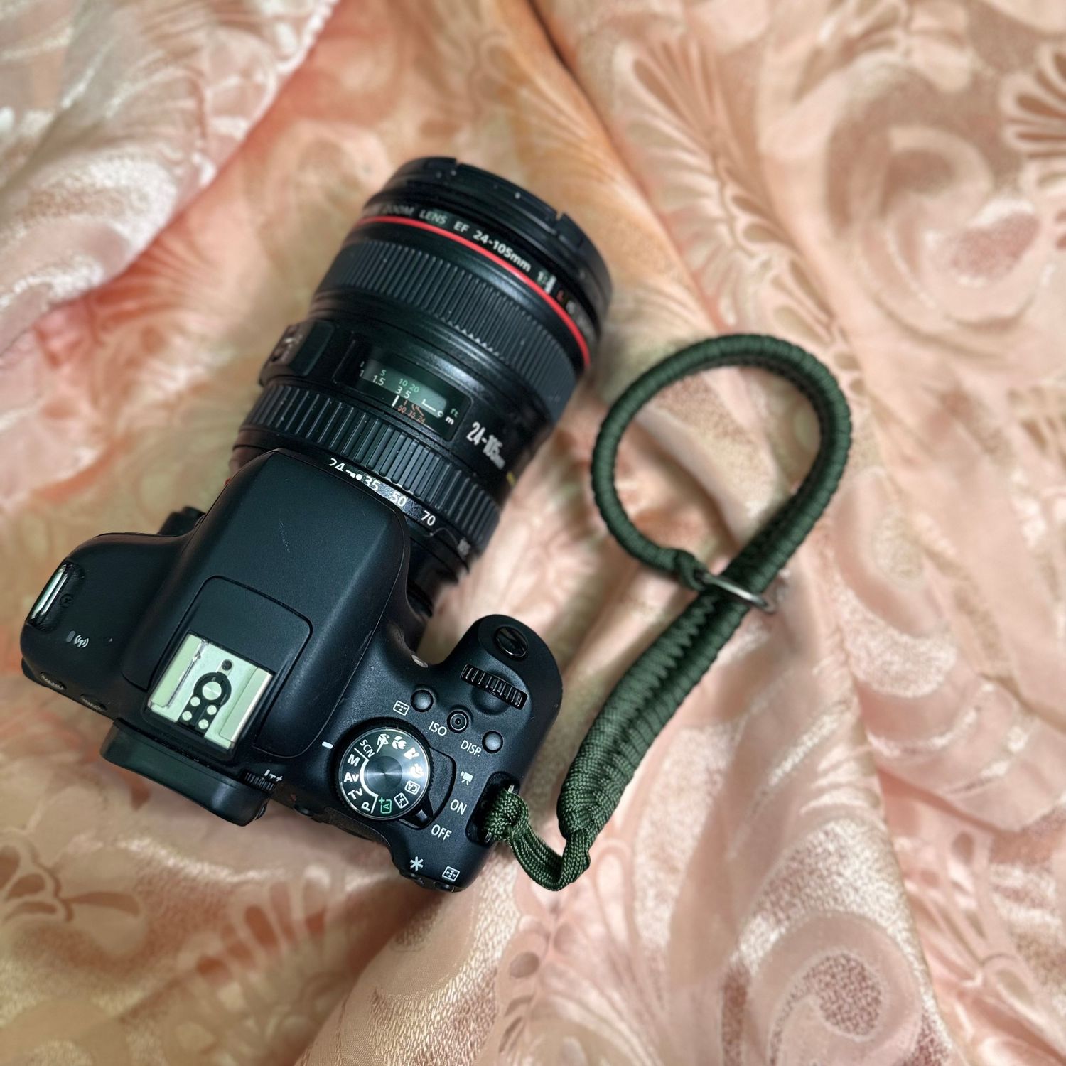 Macro photo sequence showing a DSLR camera from different angles on a textured pink fabric background.