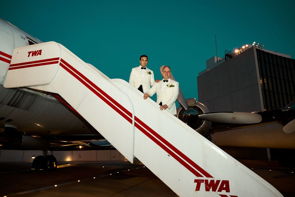 Vintage TWA aircraft on display with distinctive red and white livery. gay couple wedding  TWA hotel