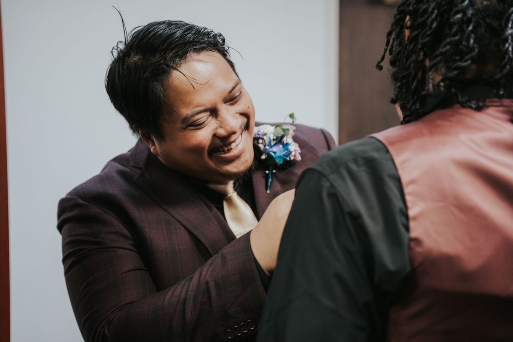 People sharing a joyful moment in heartwarming candid interaction, with person in brown jacket laughing.