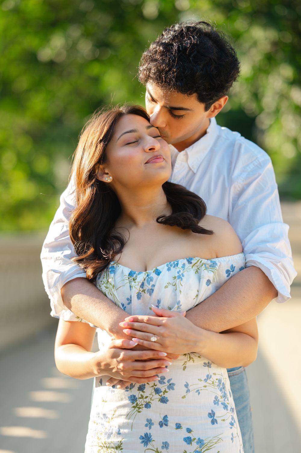 A newly engaged couple poses for engagement photos in Central Park after a surprise proposal. Photos by Joliette Marie Photography.