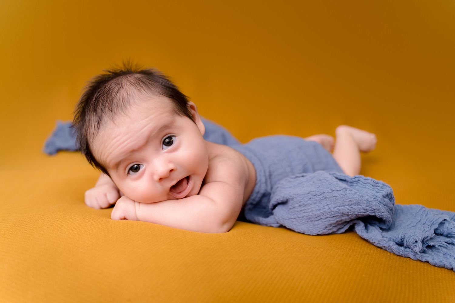 Newborn photoshoot Saskatoon and Warman, blue wrap baby newborn boy in bright beautiful colors
