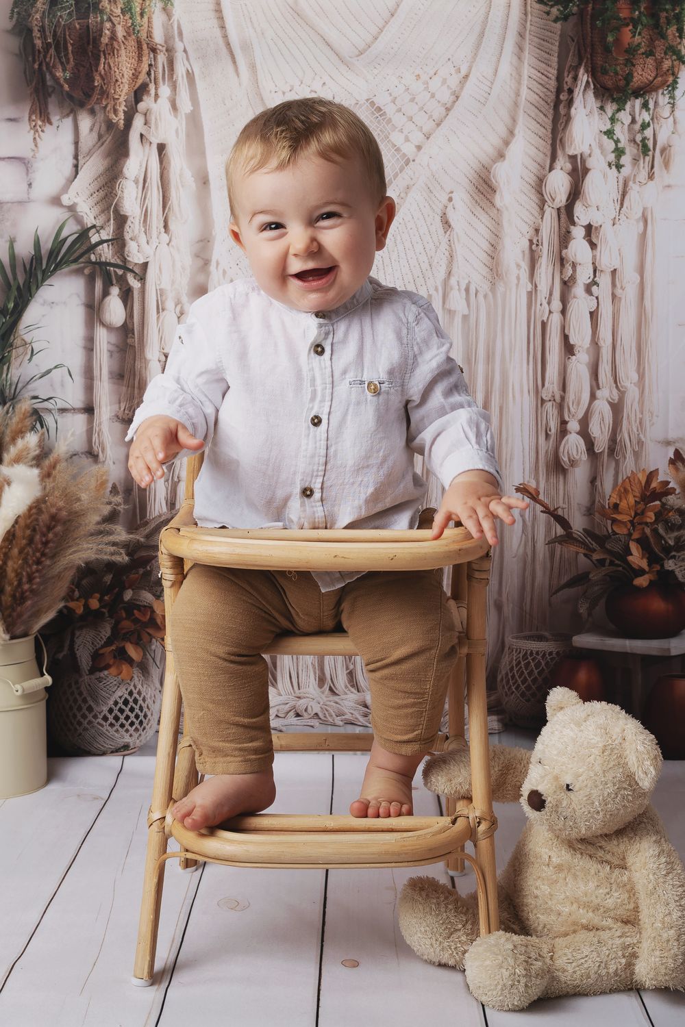 A series of photos showing a small child in a white shirt and tan pants playing with a wooden rocking chair and teddy bear.