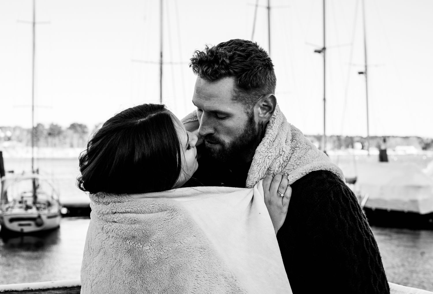 Black and white sequence showing silhouettes against a harbor background.