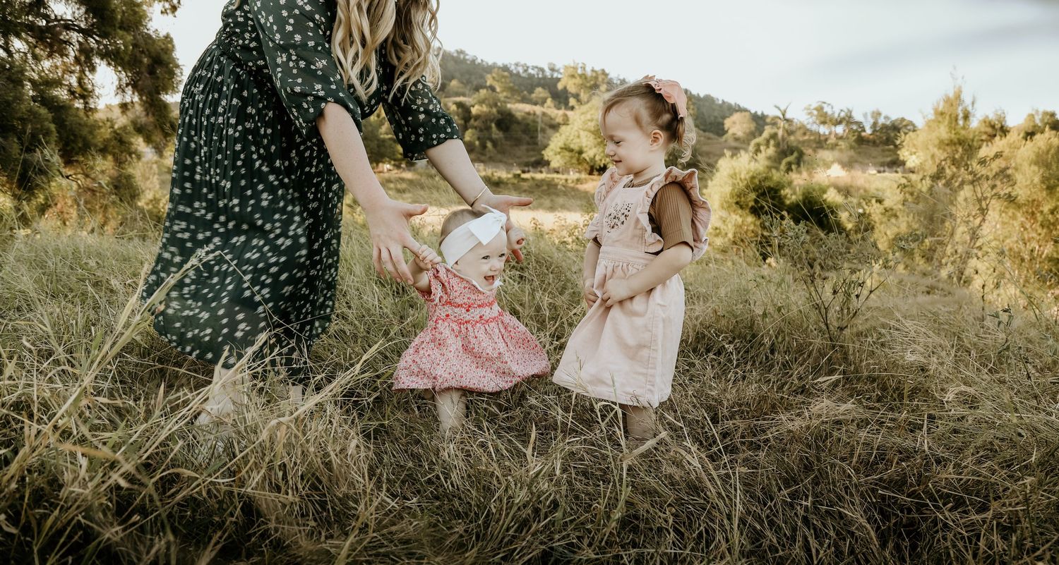 two girls walking with mum