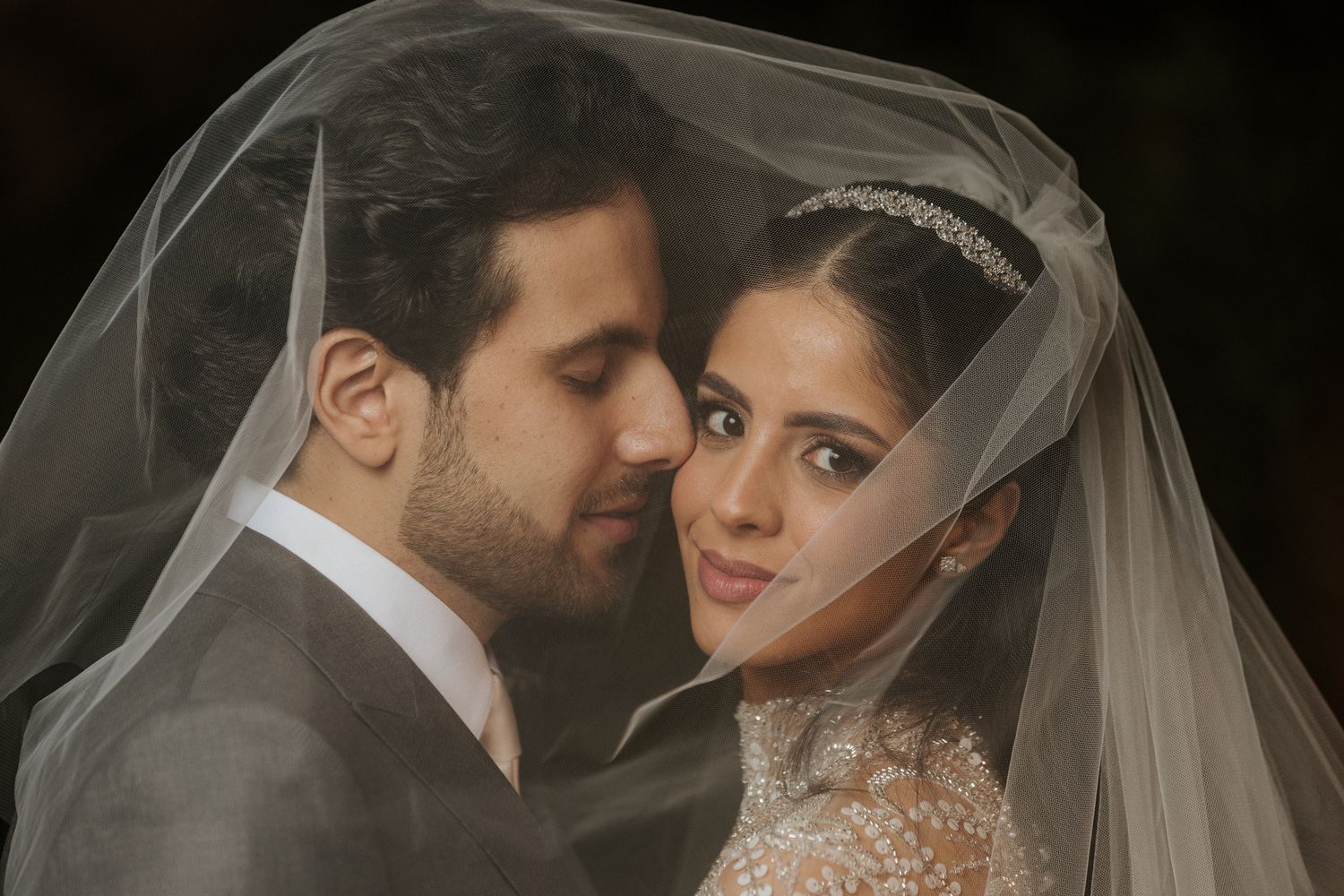 Intimate wedding portrait session featuring romantic poses and delicate veil details.