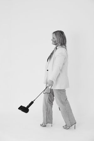 Fashion model in white blazer and light jeans poses in three different positions against white background.