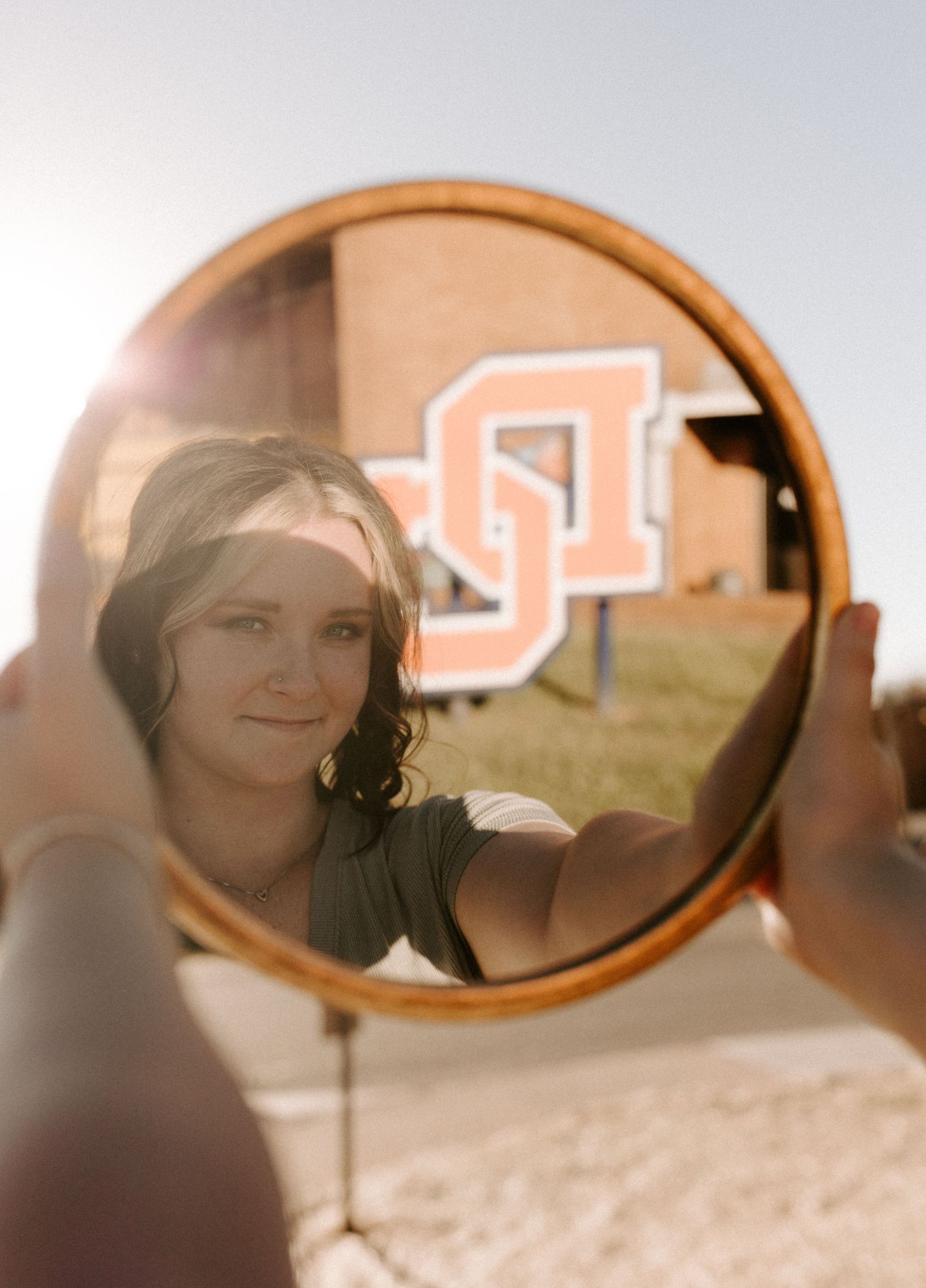Creative mirror reflection shot with DC logo visible in background.