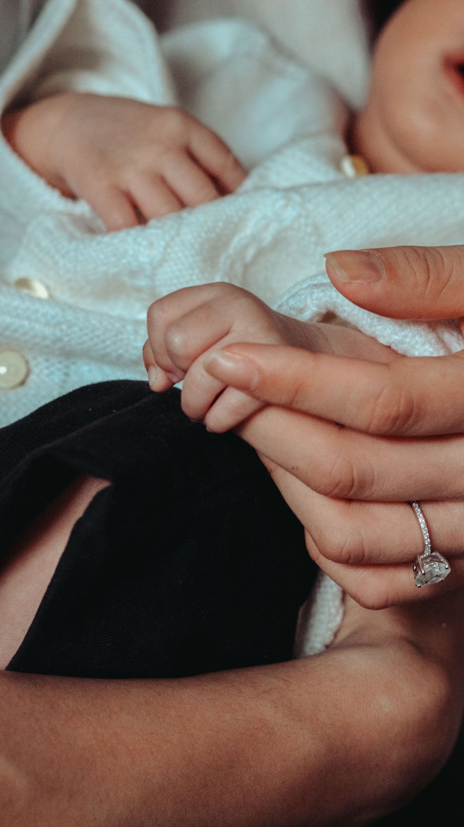 newborn holding parent finger