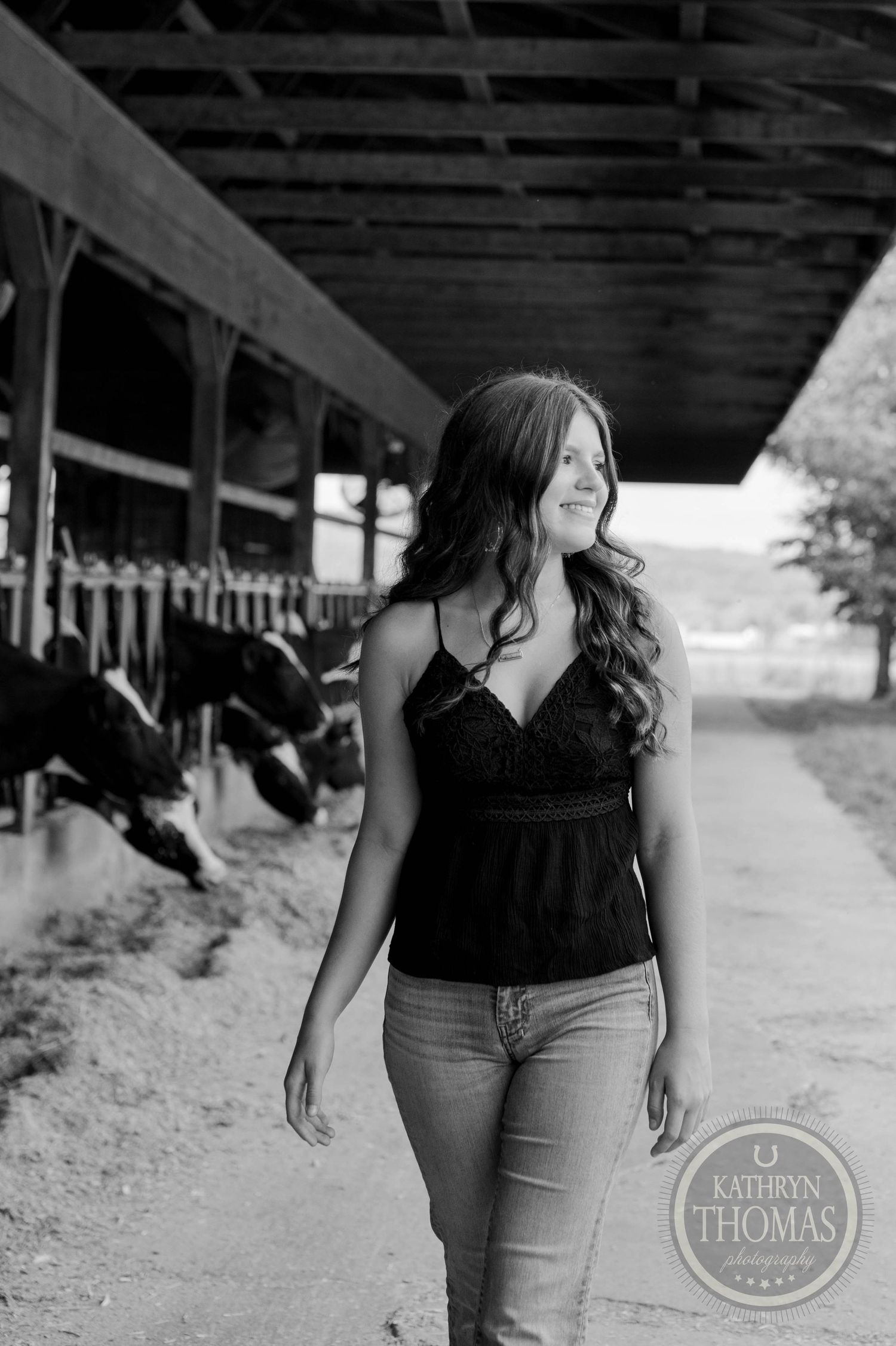 Black and white portrait of casual outfit against dairy barn interior.