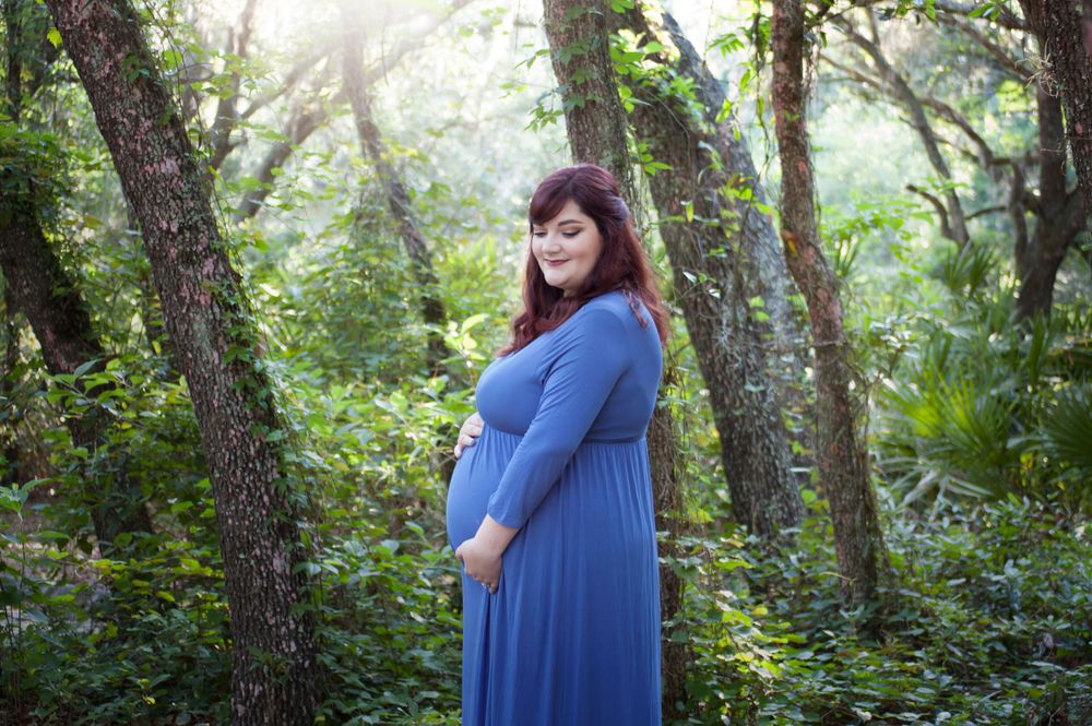 Solo maternity session new baby on the way. It's a boy! Mom dressed in blue. Natural lighting at lettuce park near Tampa Florida