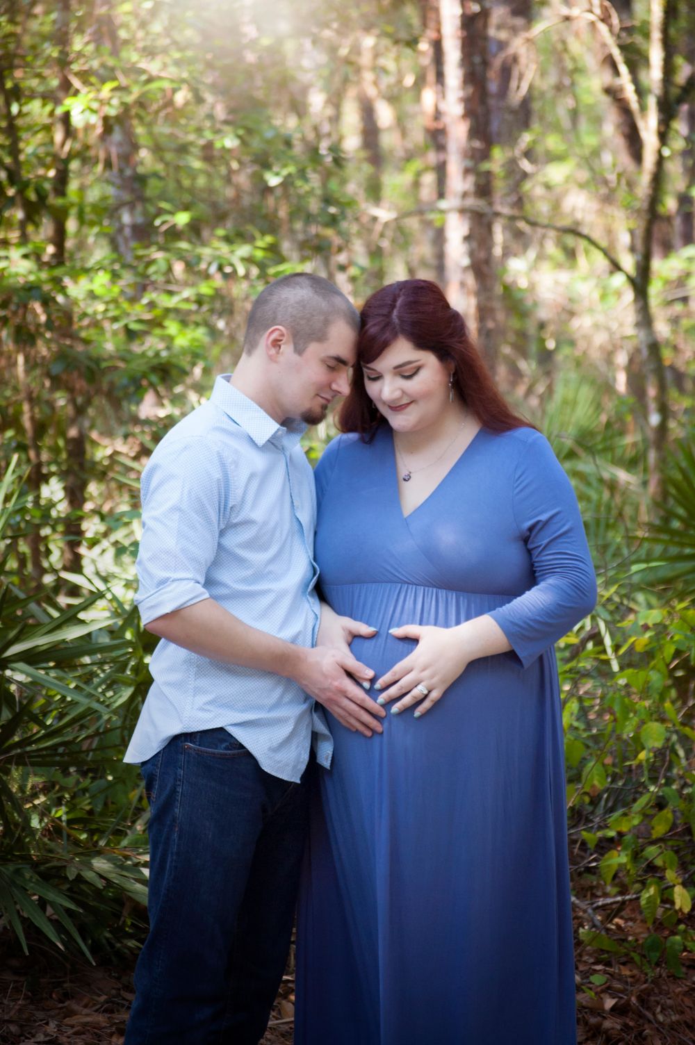 Duo maternity session new baby on the way. It's a boy! Mom dressed in blue. Natural lighting at lettuce park near Tampa Florida