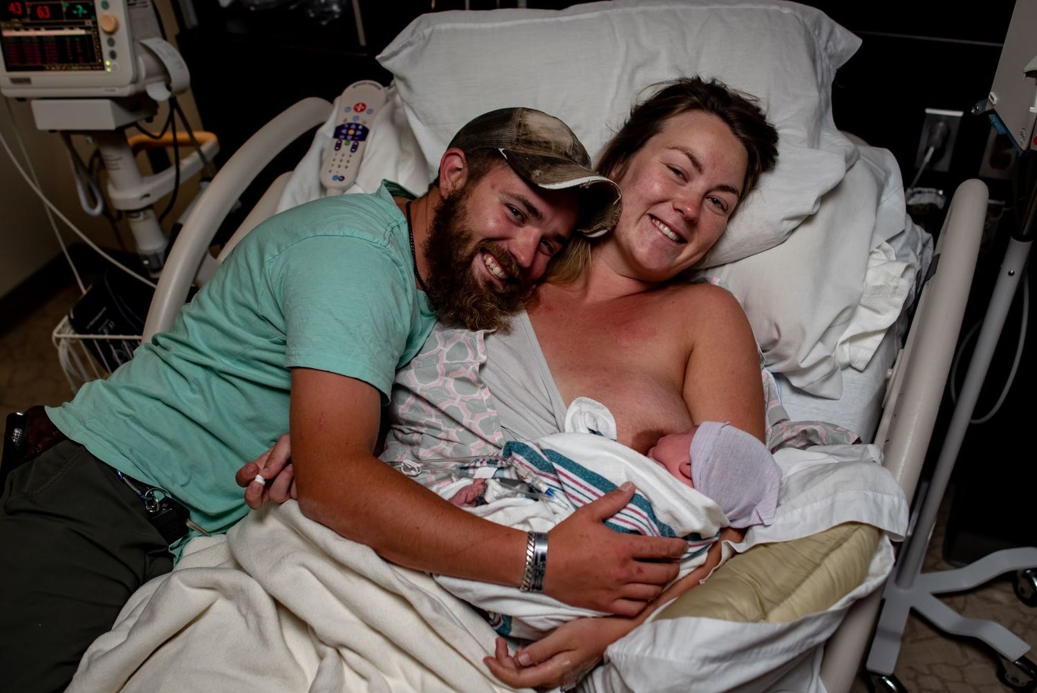 A tender moment shared with a newborn in a hospital bed.