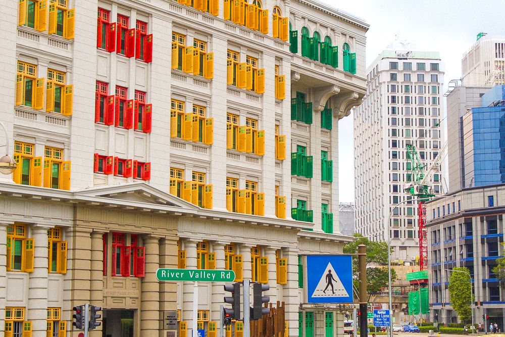 Colorful building with red, yellow, and green shuttered windows on River Valley Road in Singapore.