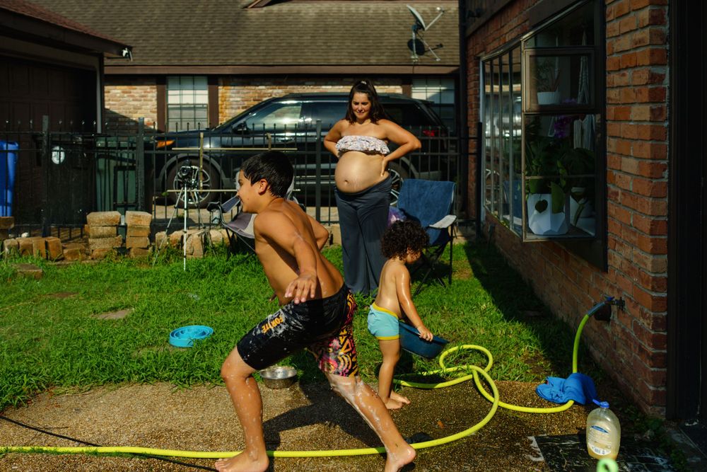 A colorful inflatable water slide setup in a backyard on a sunny day.