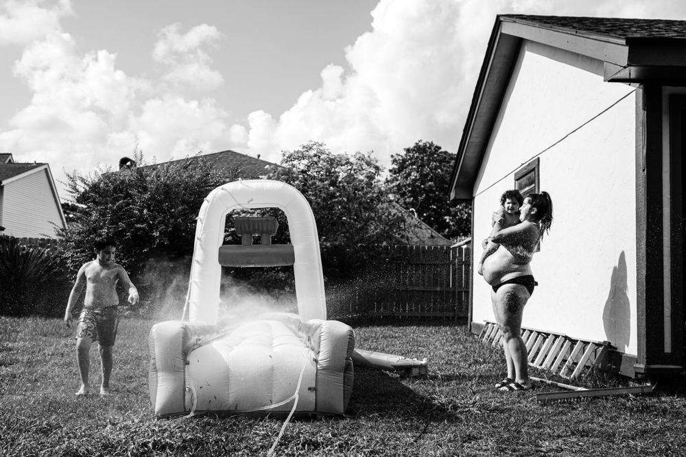 Black and white sequence showing water play activities in a backyard.