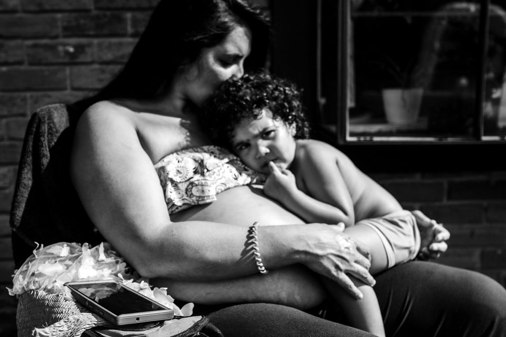Black and white intimate portrait of tender moment between parent and child.