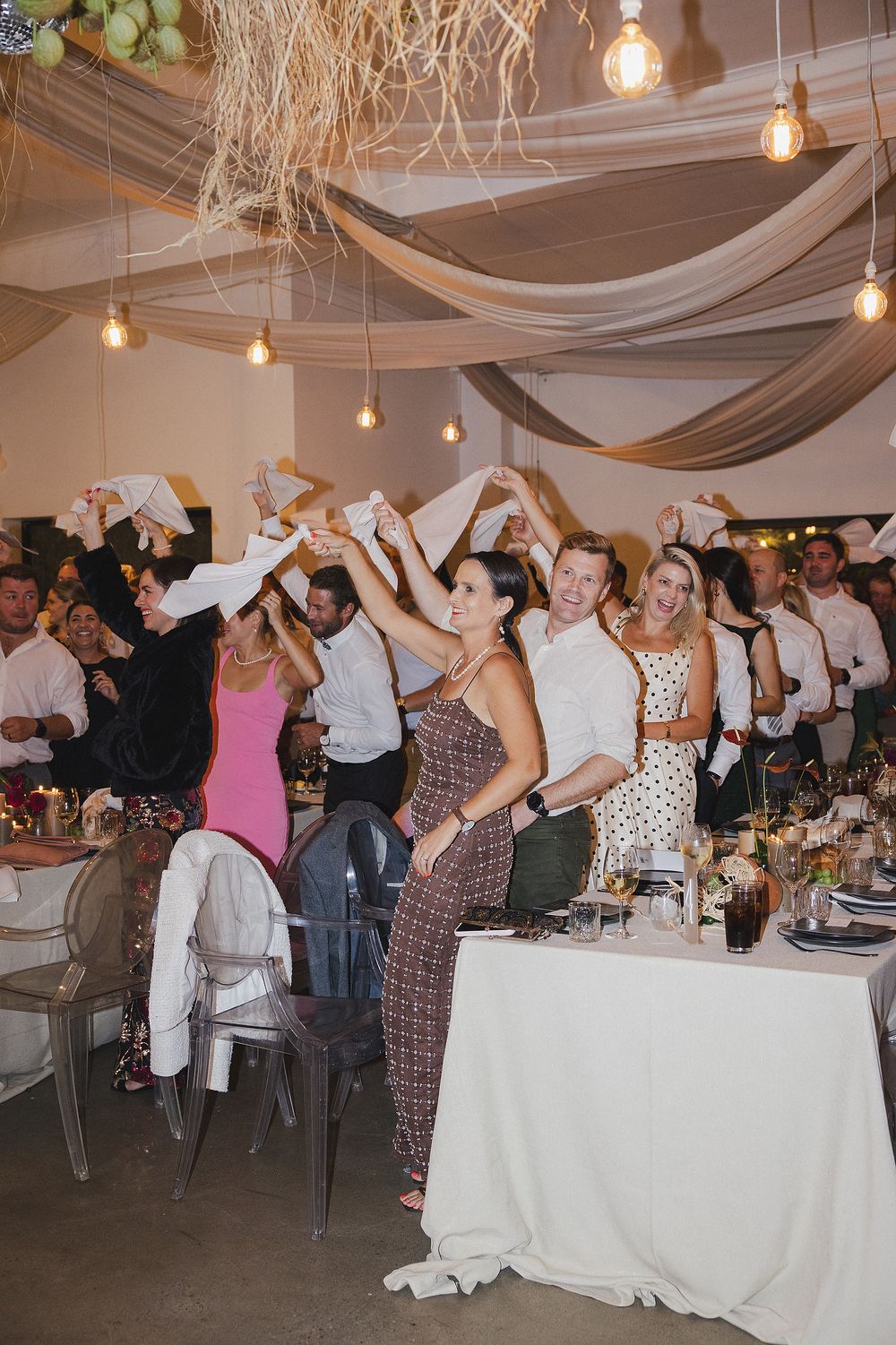 Bride and groom dancing with guests during joyful wedding celebration