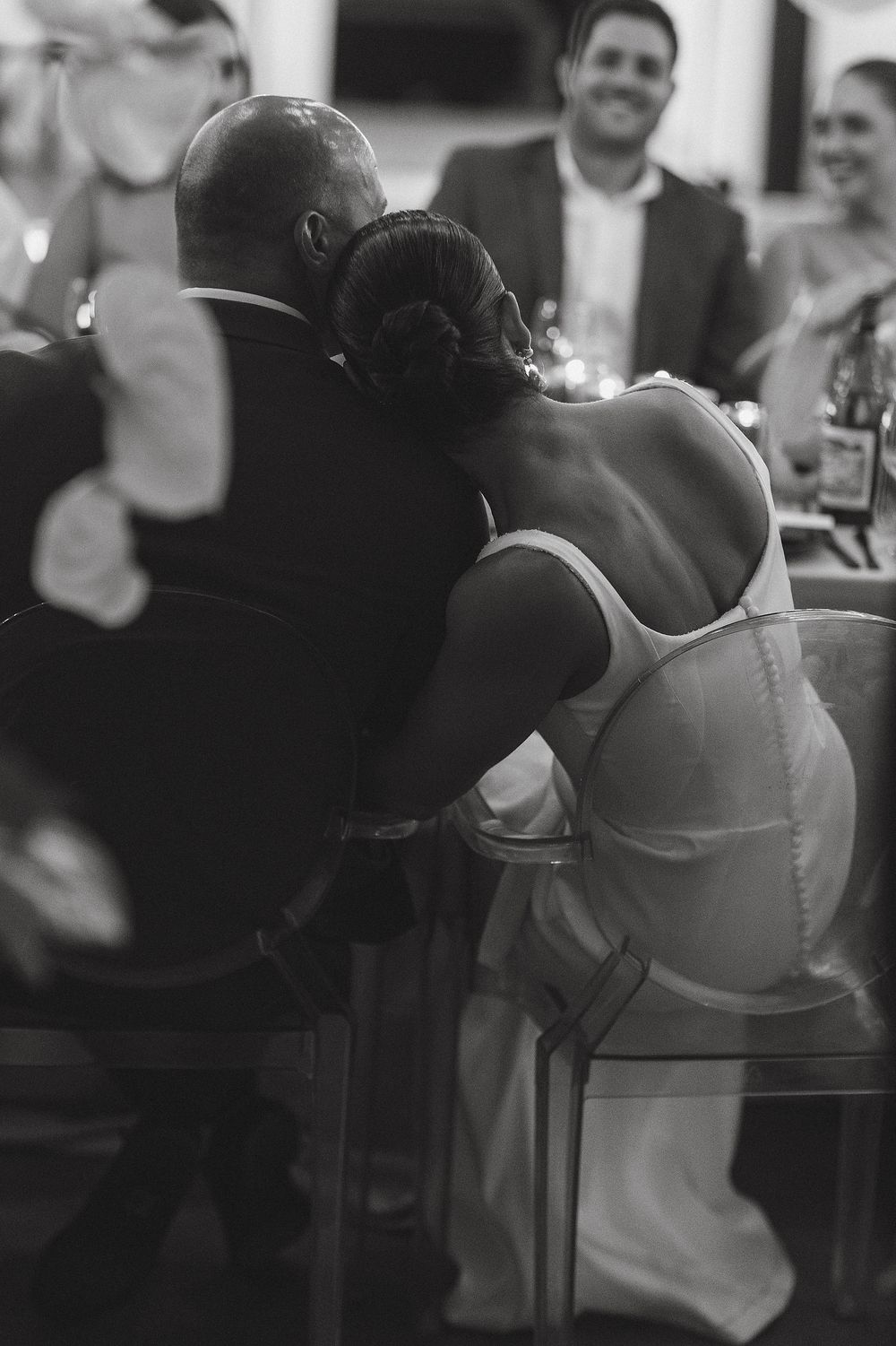 Bride and groom sharing emotional moments during wedding reception speeches