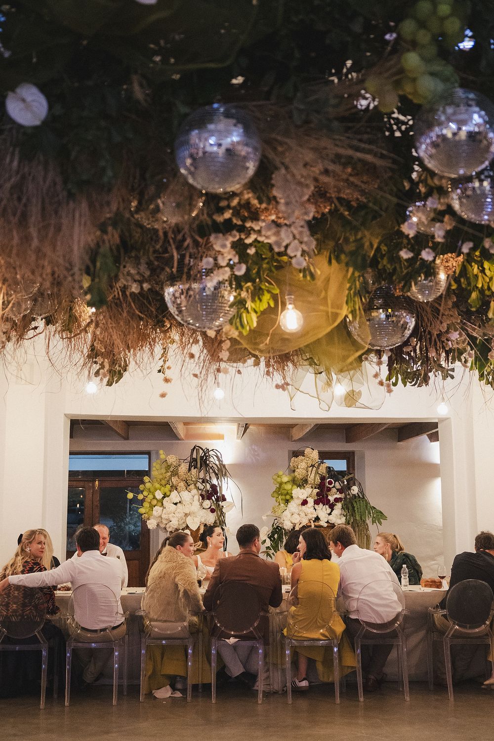Elegant wedding reception styled with candles, florals and soft ambient lighting