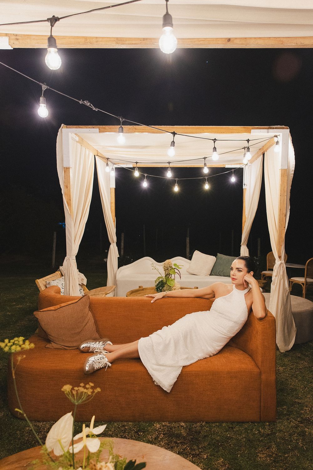 Bride seated elegantly on reception lounge couch during romantic wedding celebration