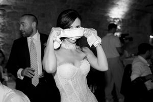 Black and white photo of bride in strapless gown dancing at wedding reception.