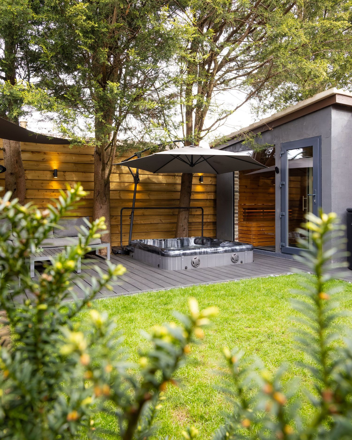 Outdoor hot tub at Bedfordshire garden spa with decking and seating, photographed for spa photography shoot