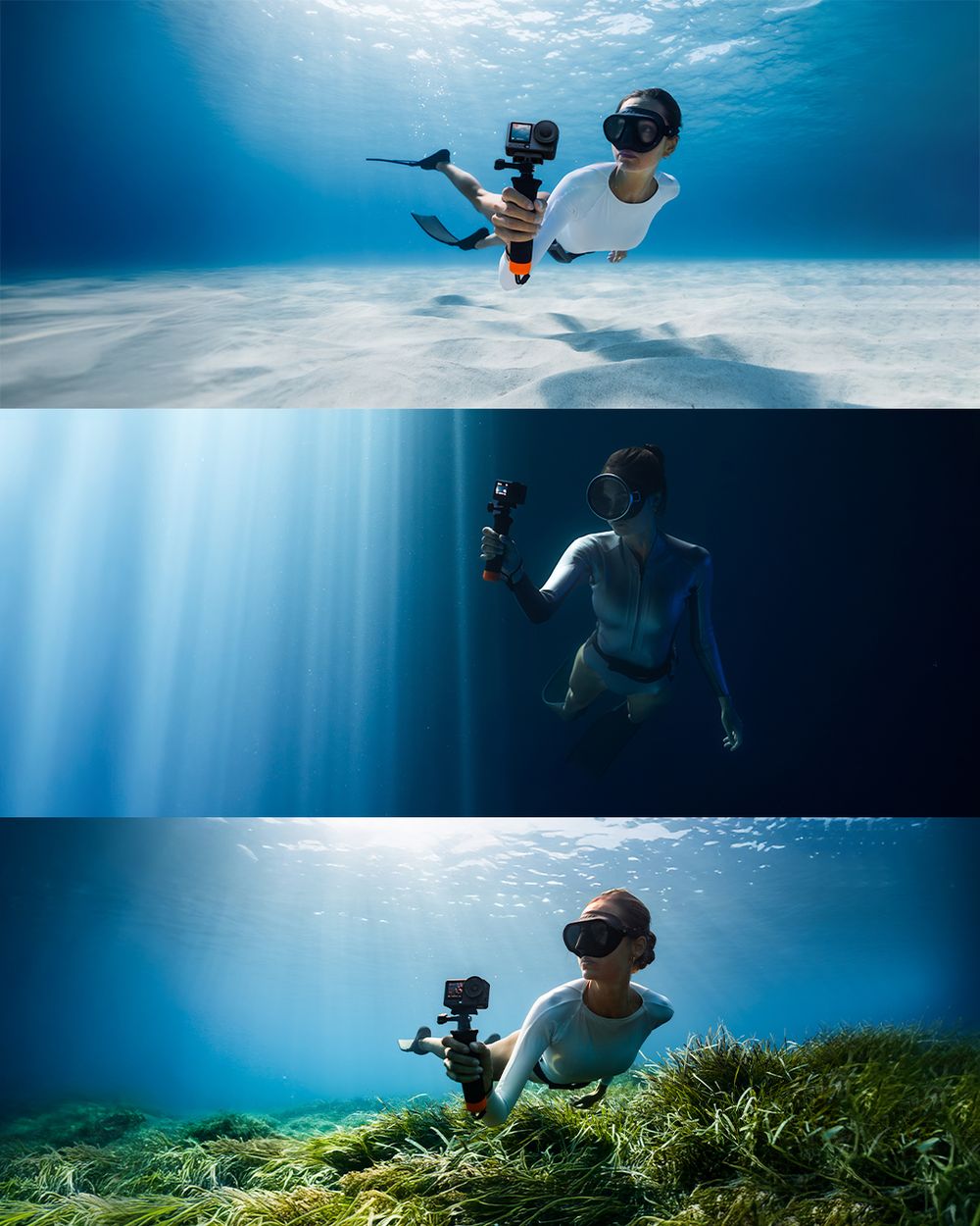 Underwater photographer diving with GoPro camera on selfie stick in crystal clear blue ocean water above sandy seabed.