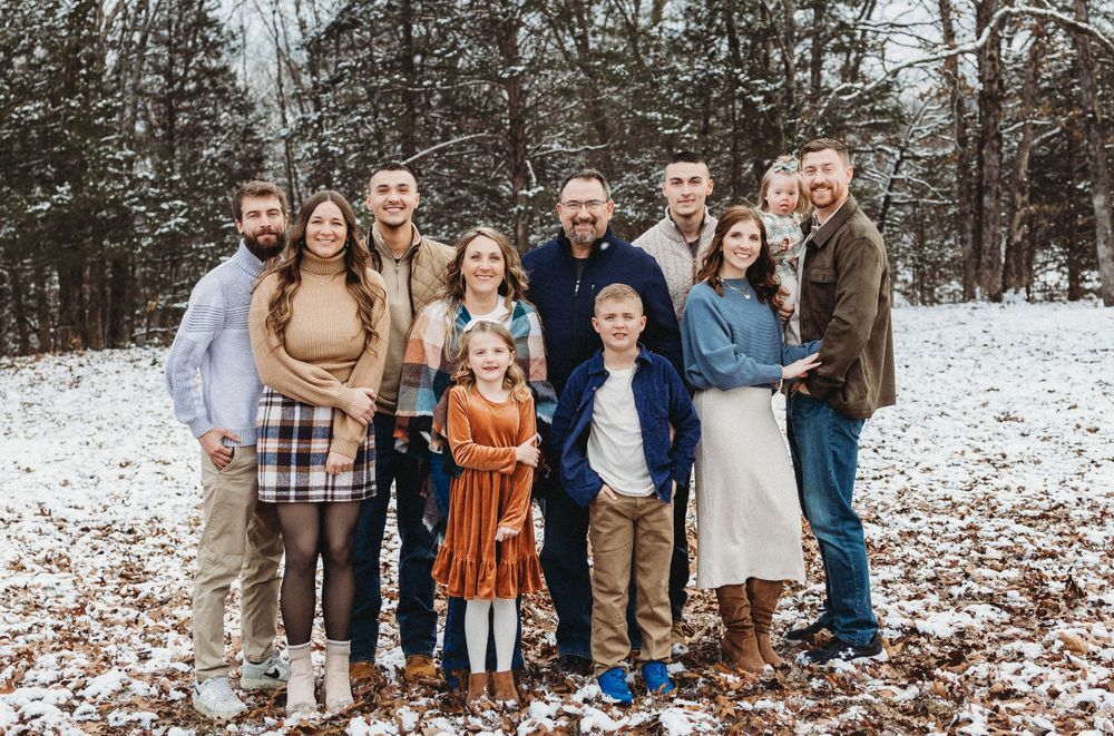 family photo in snow couple, brothers, grandparents grandkids