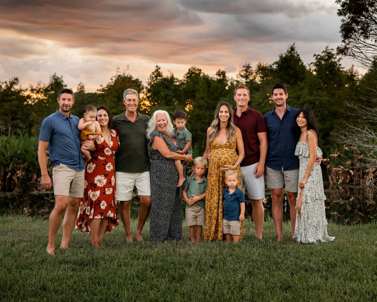 Extended family portrait at sunset featuring grandparents, parents, children, and grandchildren gathered outdoors in Florida.