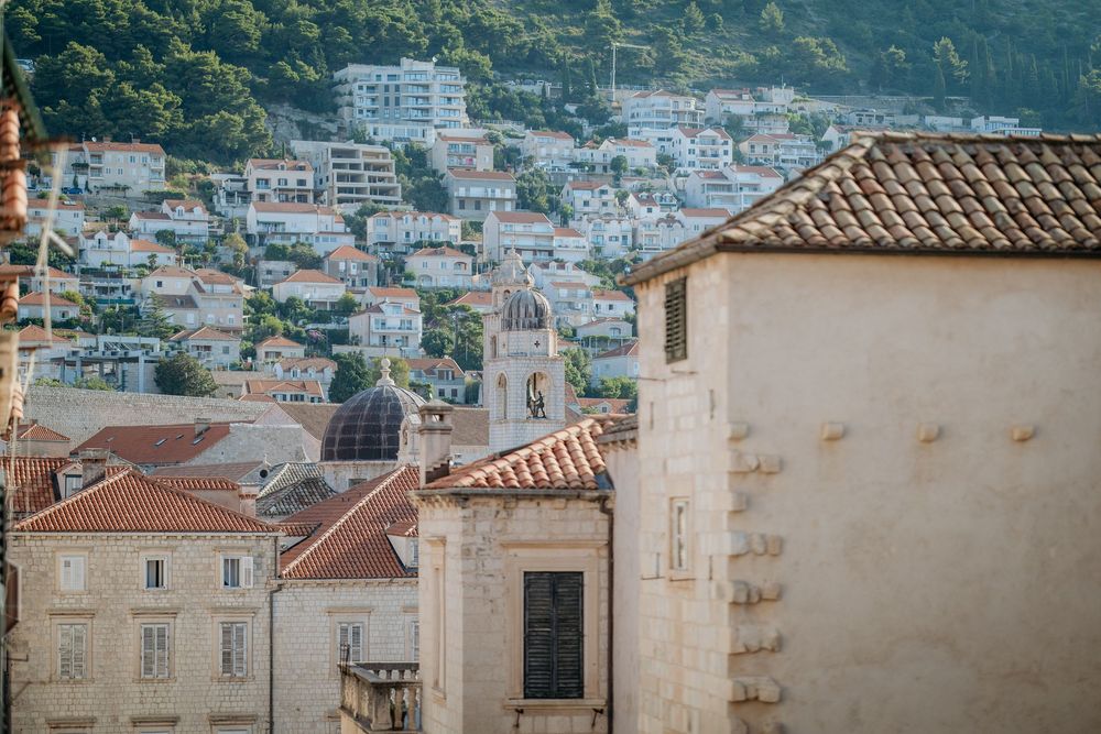 Scenic aerial view of a Mediterranean coastal town with terracotta rooftops.