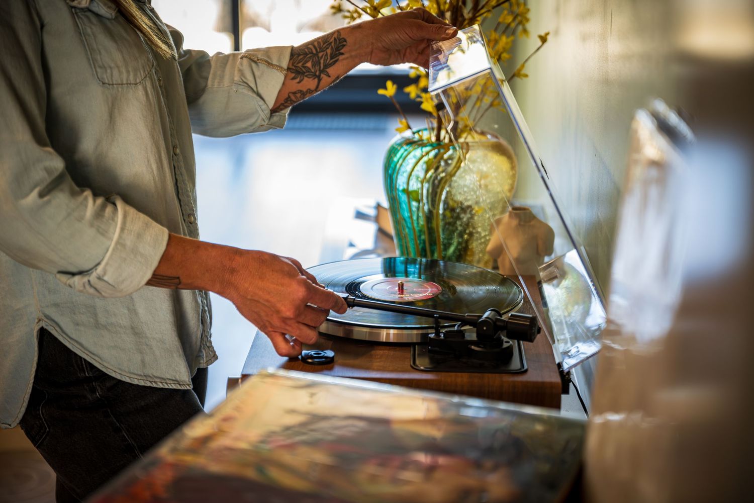 Woman placing a record on the player at the vacation rental property, Stillwater Luxury in Black Hawk, CO.