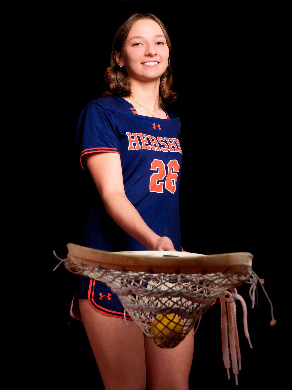 Hershey Lacrosse senior #28 poses with lacrosse goalie stick and ball, Media Day by Deanna Fox, SportsFox Photography based in Hershey PA