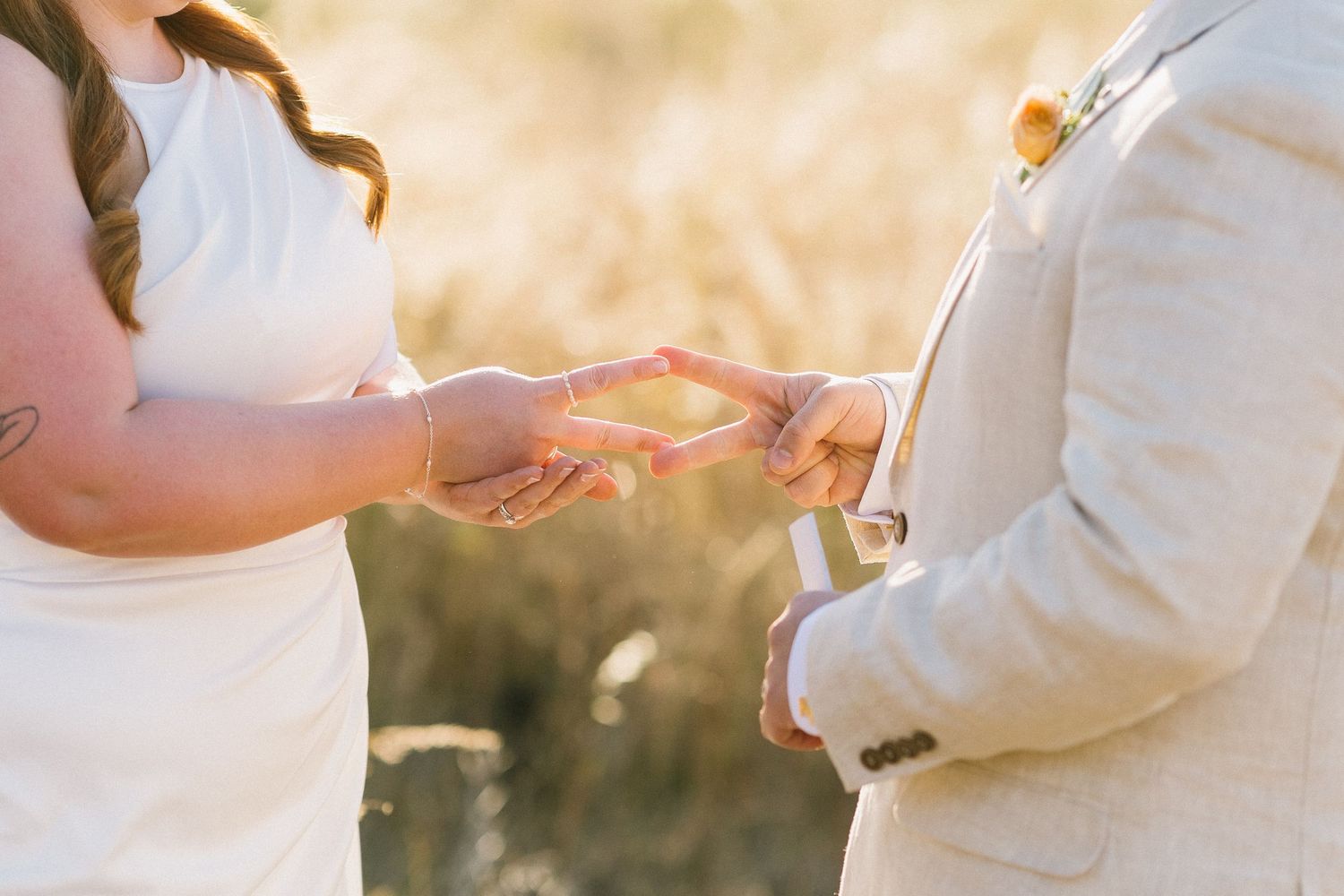 Bride and groom clinking espresso martini cocktails during golden hour at outdoor wedding reception.