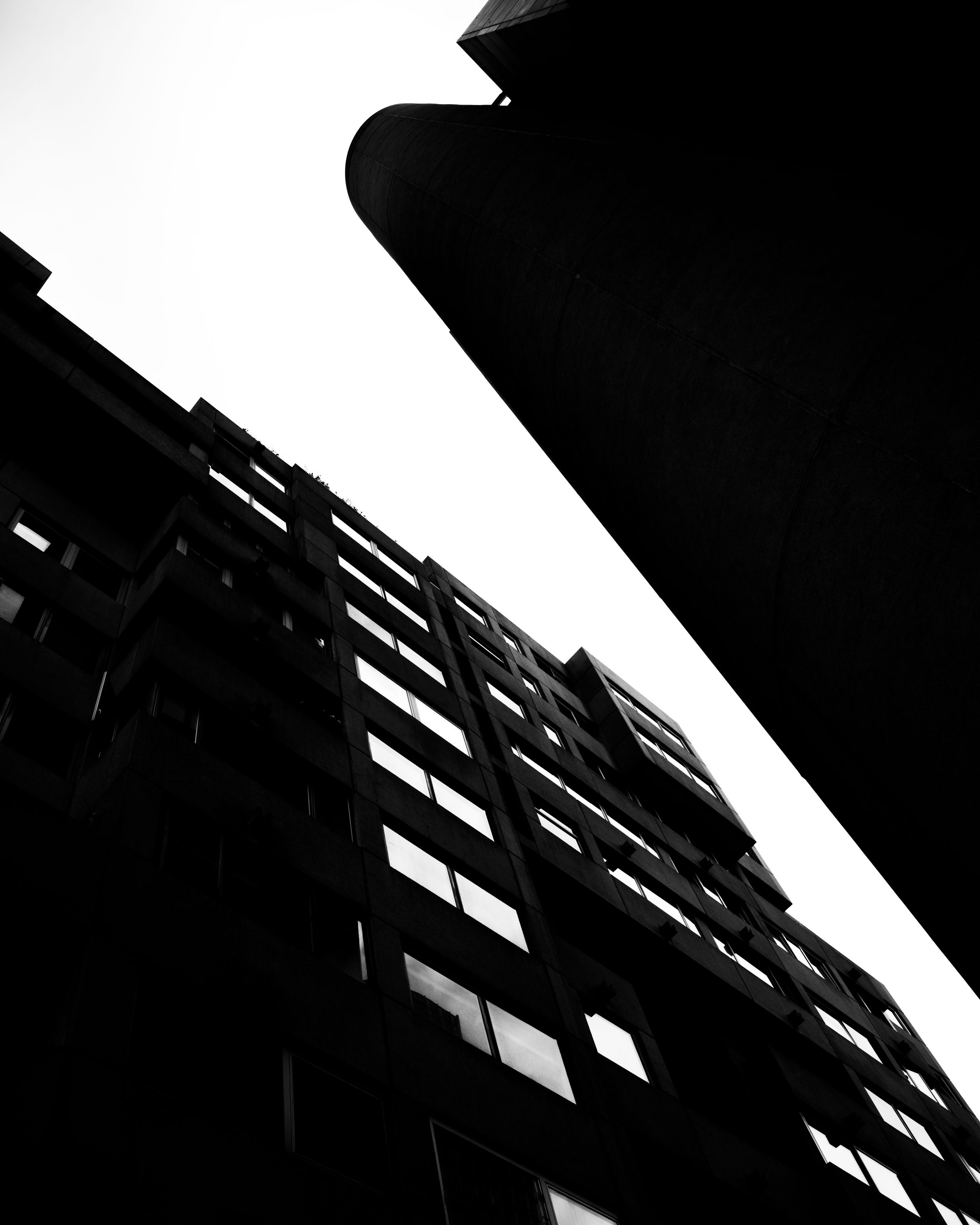 Black and white architectural photo looking up at a building facade with diagonal lines