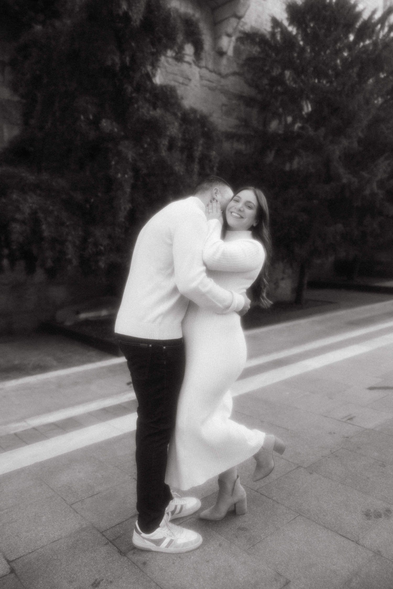 Black and white maternity dance sequence on outdoor pathway.