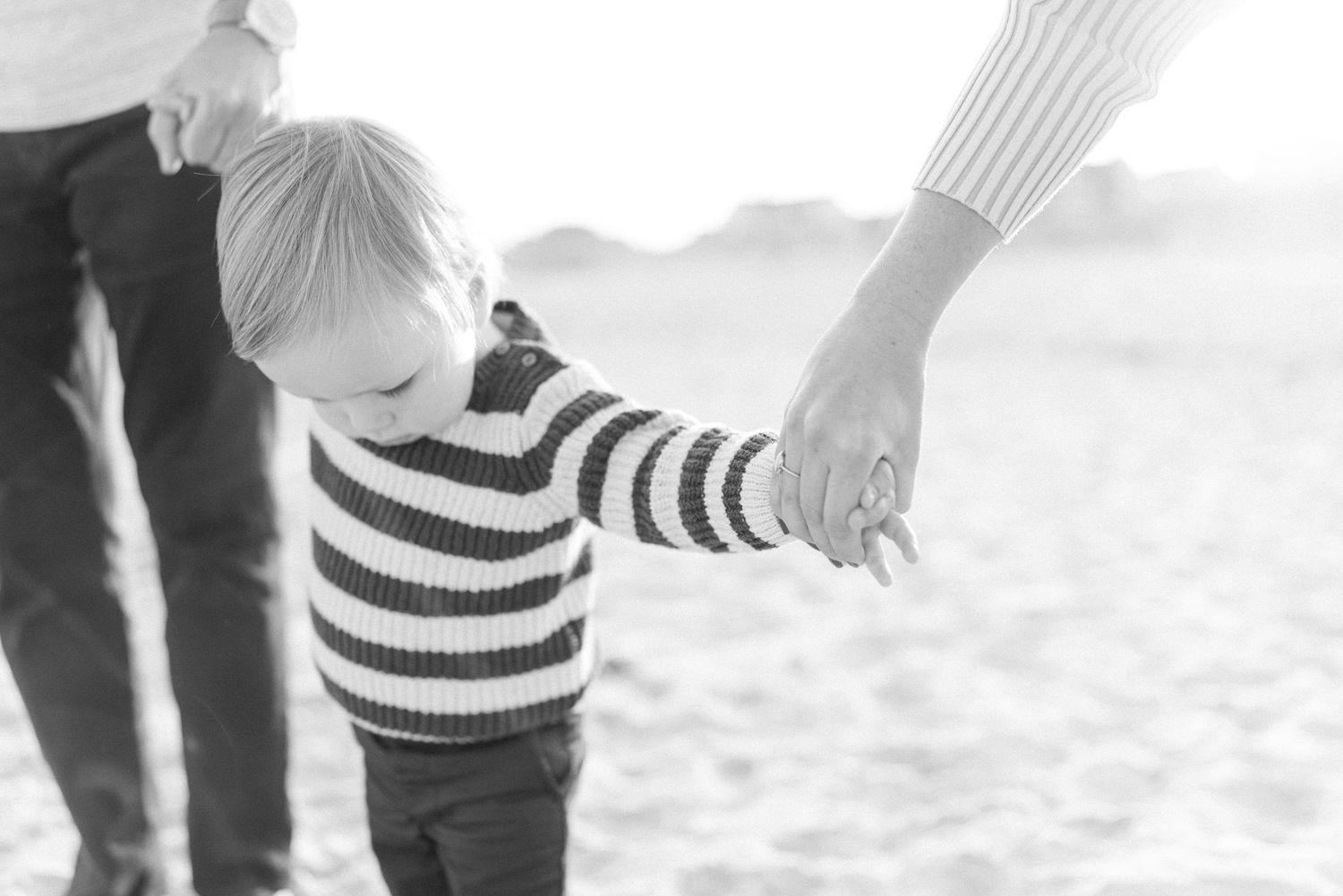 holding hands on the spring lake beach.