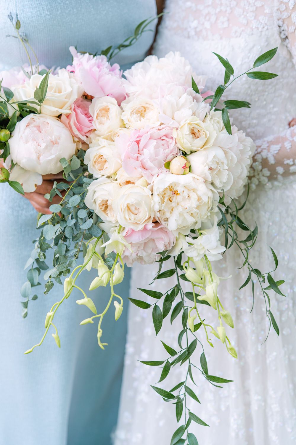 Close up of Abby’s bouquet including her grandmother’s rosary and soft pink flowers