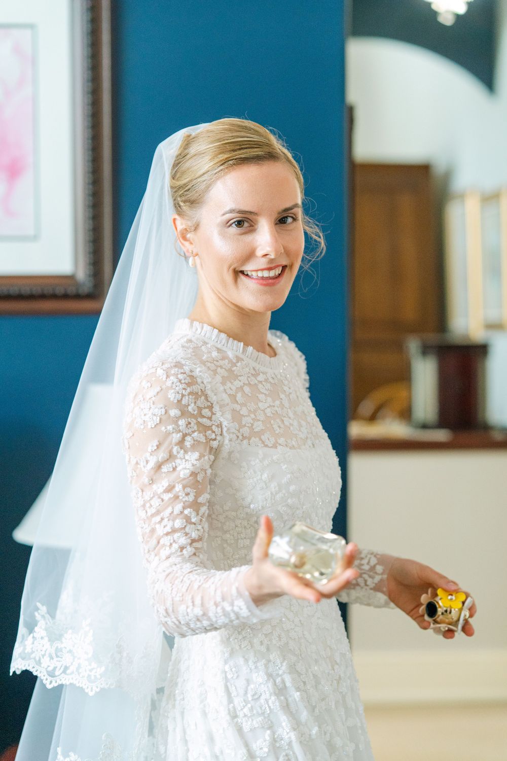 Detail shot of bride’s Needle & Thread London dress in natural sunlight with her Marc Jacobs Daisy Perfume