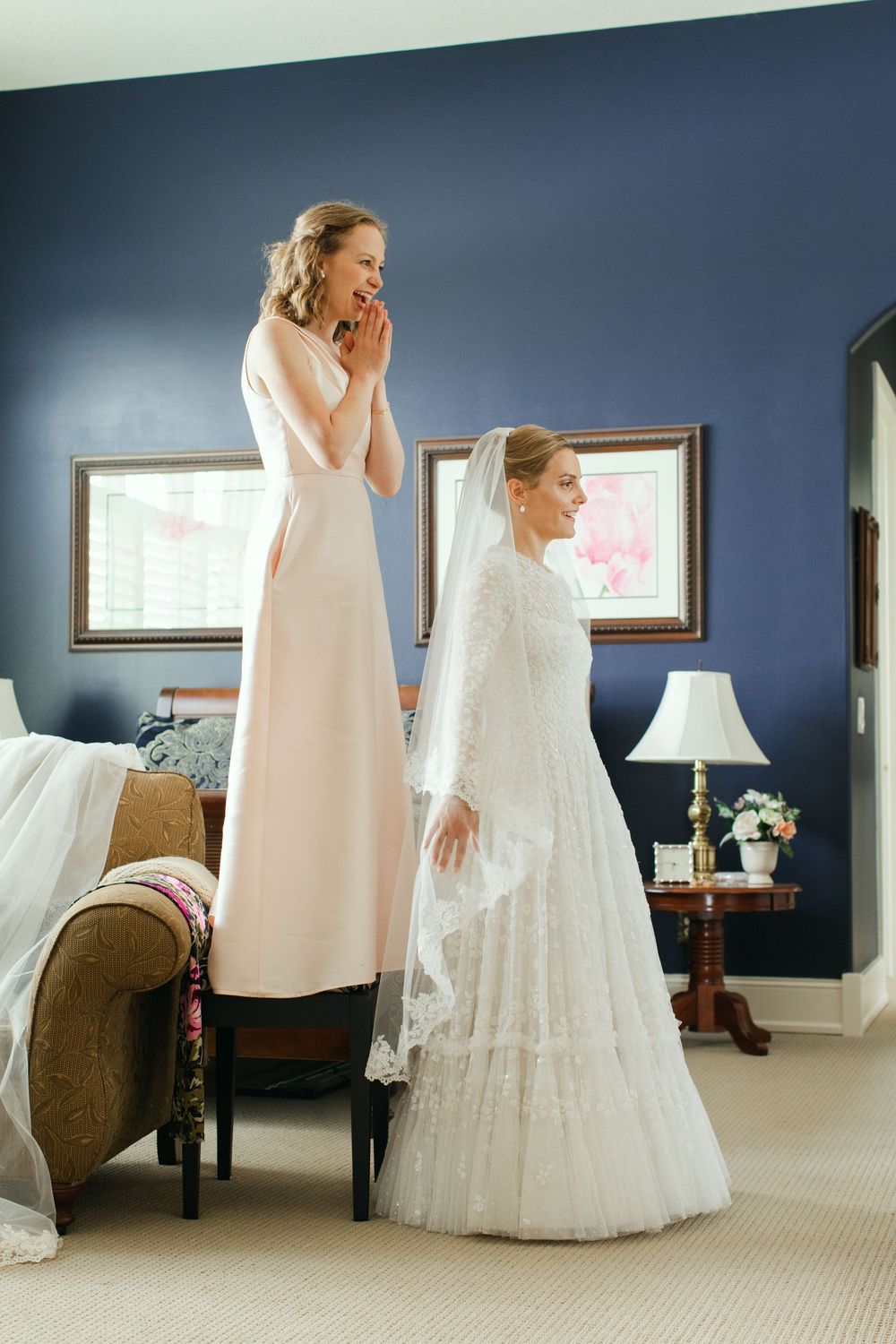 sweet getting ready portrait of a wayzata mn catholic church wedding between the matron of honor and bride