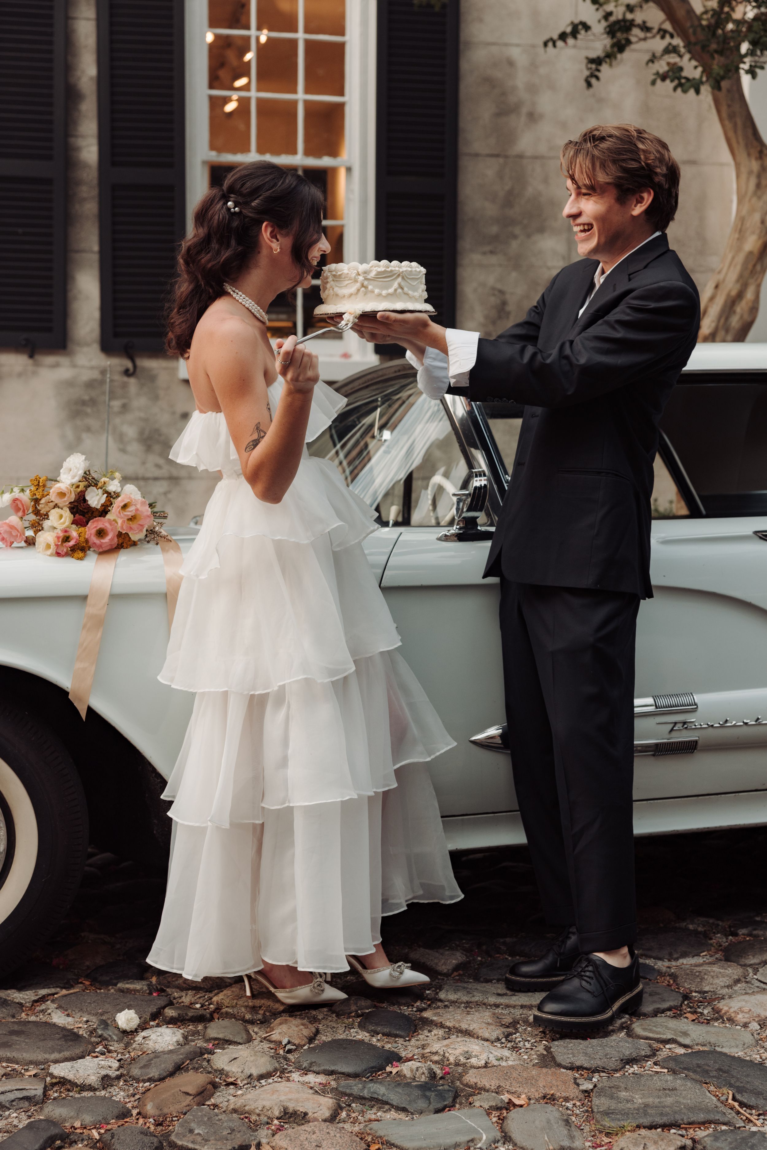 A series of candid reception photos showing a bride in a white tiered dress and groom in black suit sharing cake.