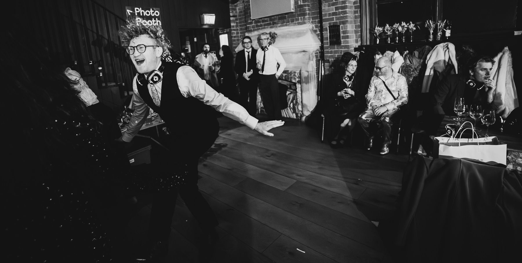 Black and white photographers capture moments at a lively wedding reception.