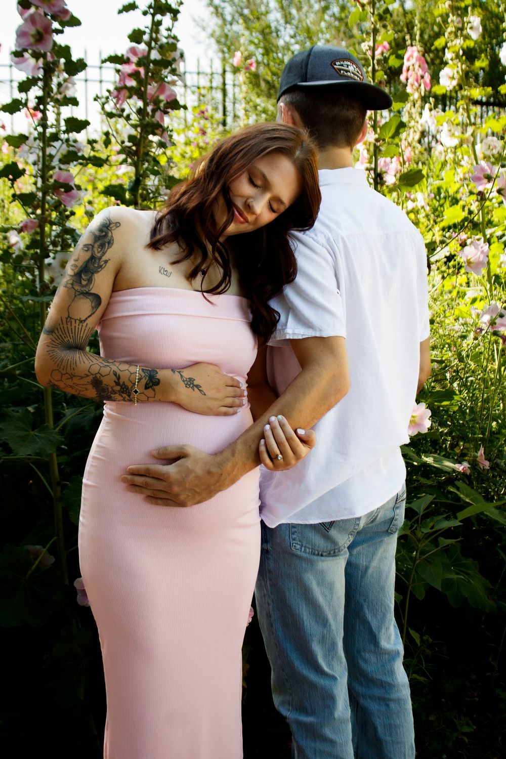 An expecting couple during a maternity photo session at the Botanical Gardens in Amarillo, Texas