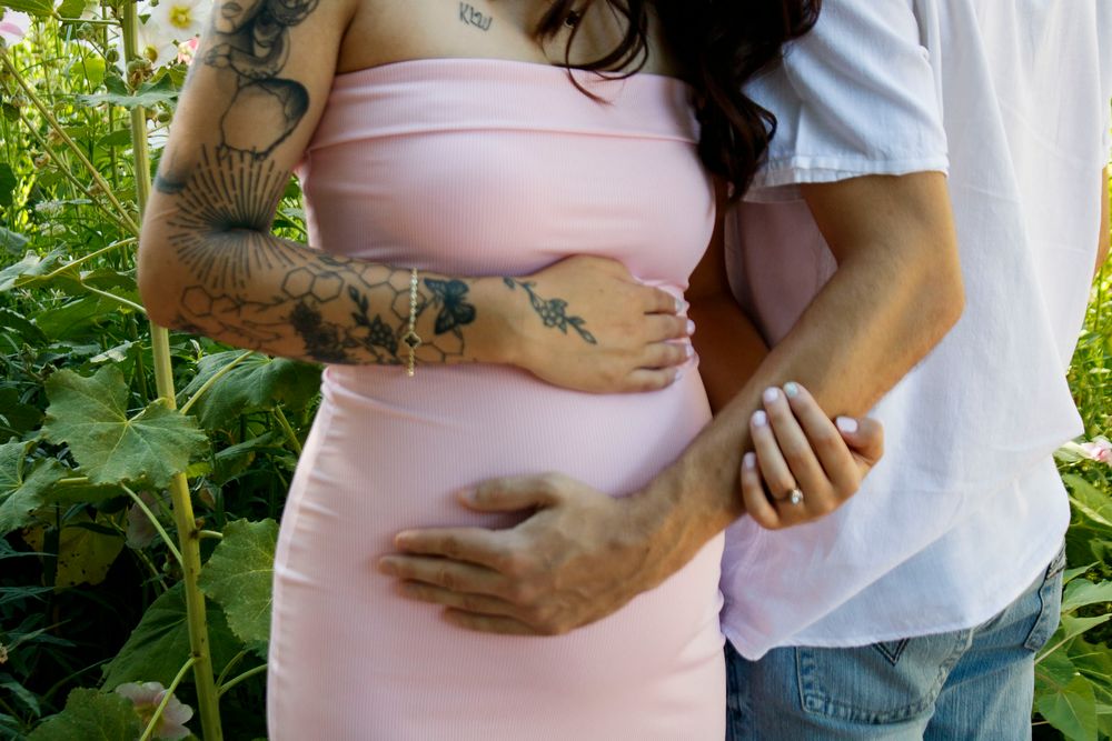 An expecting couple during a maternity photo session at the Botanical Gardens in Amarillo, Texas