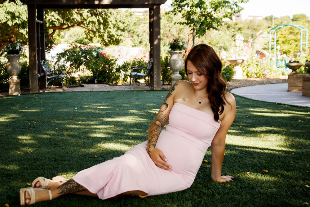 An expecting mother during a maternity photo session at the Botanical Gardens in Amarillo, Texas