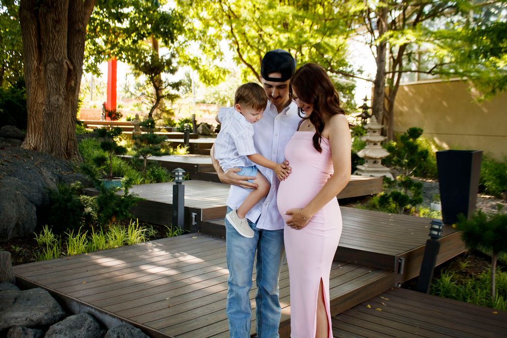 A family of three during a maternity photo session at the Botanical Gardens in Amarillo, Texas